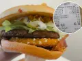 Drwal z chrzanem w burgerze, obok paragon z zakupami.