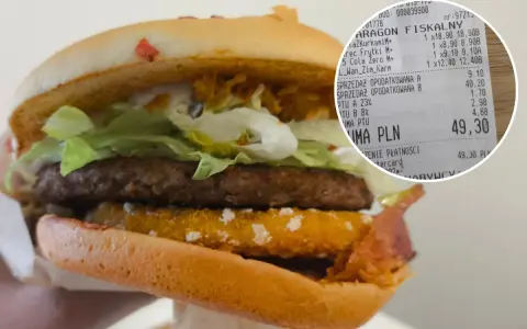 Drwal z chrzanem w burgerze, obok paragon z zakupami.