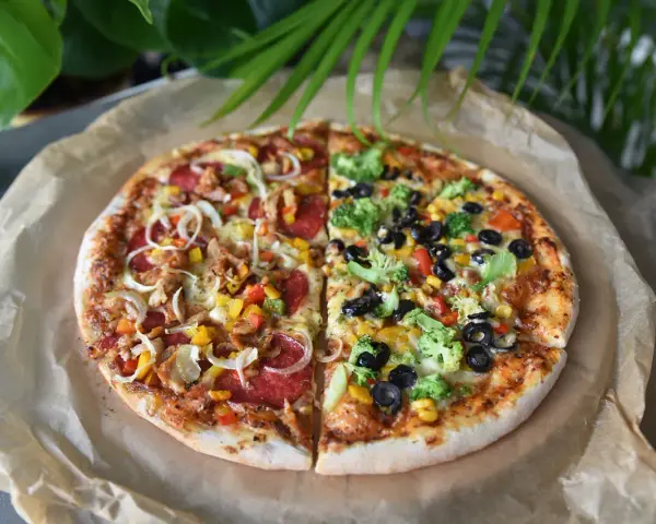 Pizza 40 cm na ile osób? Ta dwukolorowa pizza z kurczakiem, salami, warzywami i brokułami z pewnością zadowoli każdego.