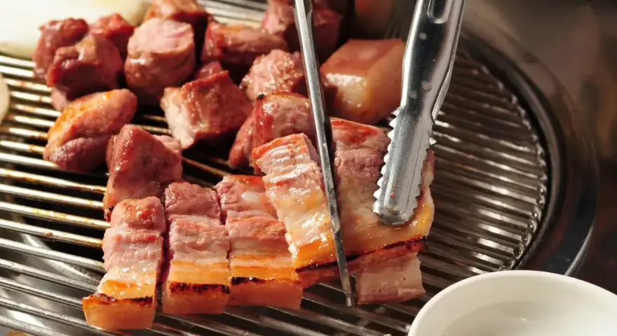 Pyszny boczek w kawałkach, grillowany na ruszcie. Idealny do marynaty, która podkreśli jego smak.