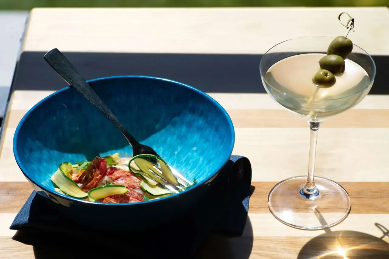 Eleganckie martini z oliwkami i miska z sałatką z krewetek i cukinii – idealne połączenie, z czym pić martini.